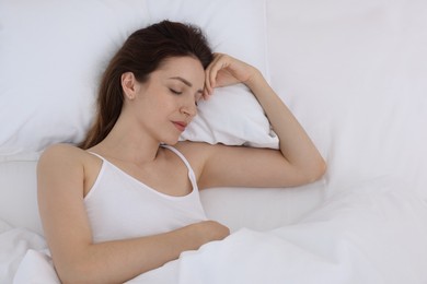 Photo of Bedtime. Woman sleeping in bed at home, above view