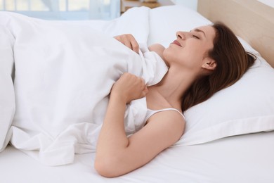 Photo of Bedtime. Woman sleeping in bed at home