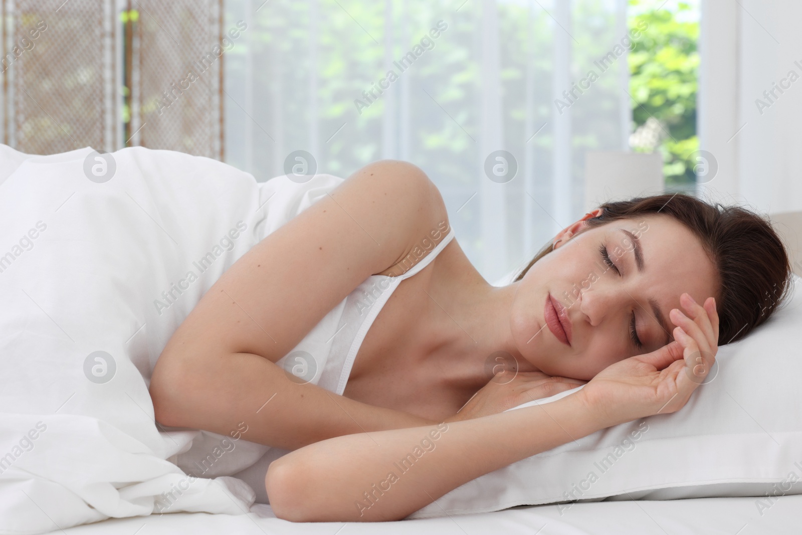 Photo of Bedtime. Woman sleeping in bed at home