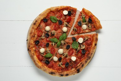 Photo of Tasty pizza on white wooden table, top view