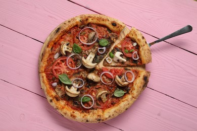 Photo of Tasty pizza with mushrooms, basil and tomatoes on pink wooden table, top view