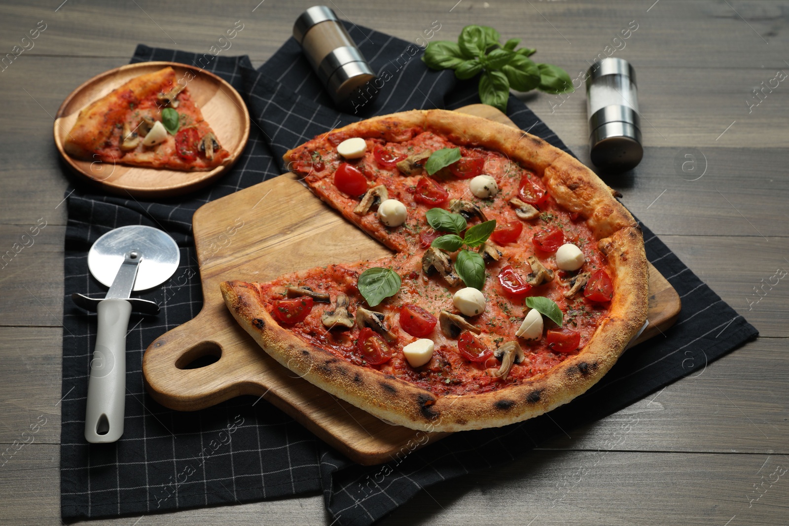 Photo of Tasty pizza with mushrooms, mozzarella and tomatoes on wooden table, closeup