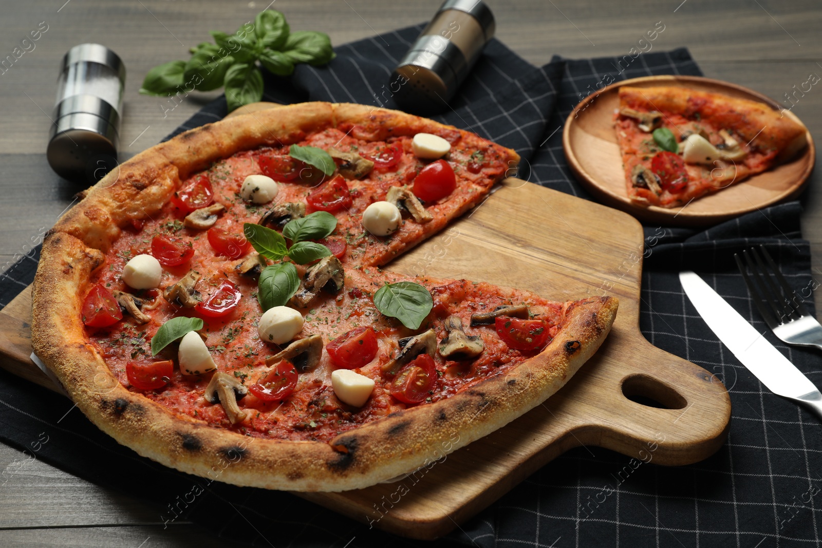 Photo of Tasty pizza with mushrooms, mozzarella and tomatoes on wooden table, closeup