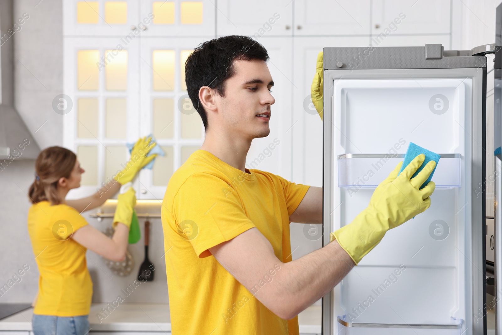 Photo of Professional janitors working in kitchen. Cleaning service