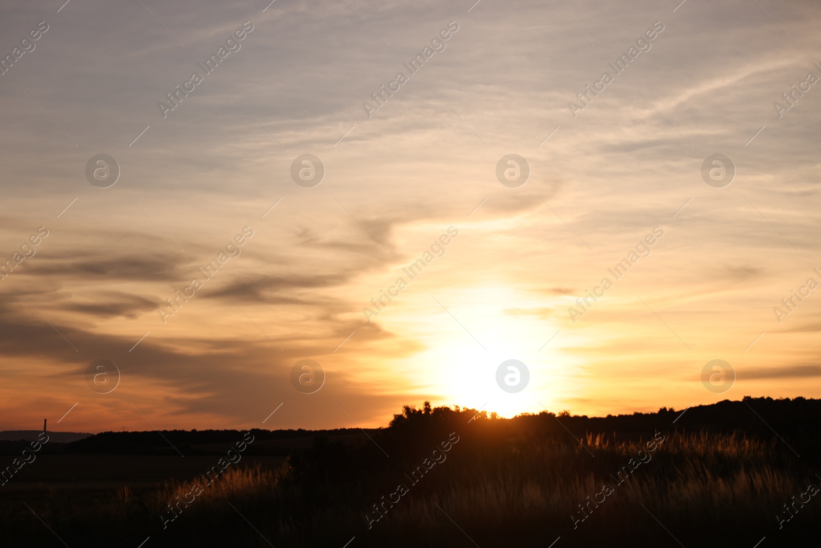 Photo of Picturesque view of countryside under beautiful sky at sunset