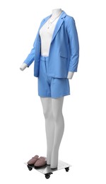 Photo of Female mannequin dressed in light blue suit and top with accessories isolated on white. Stylish outfit