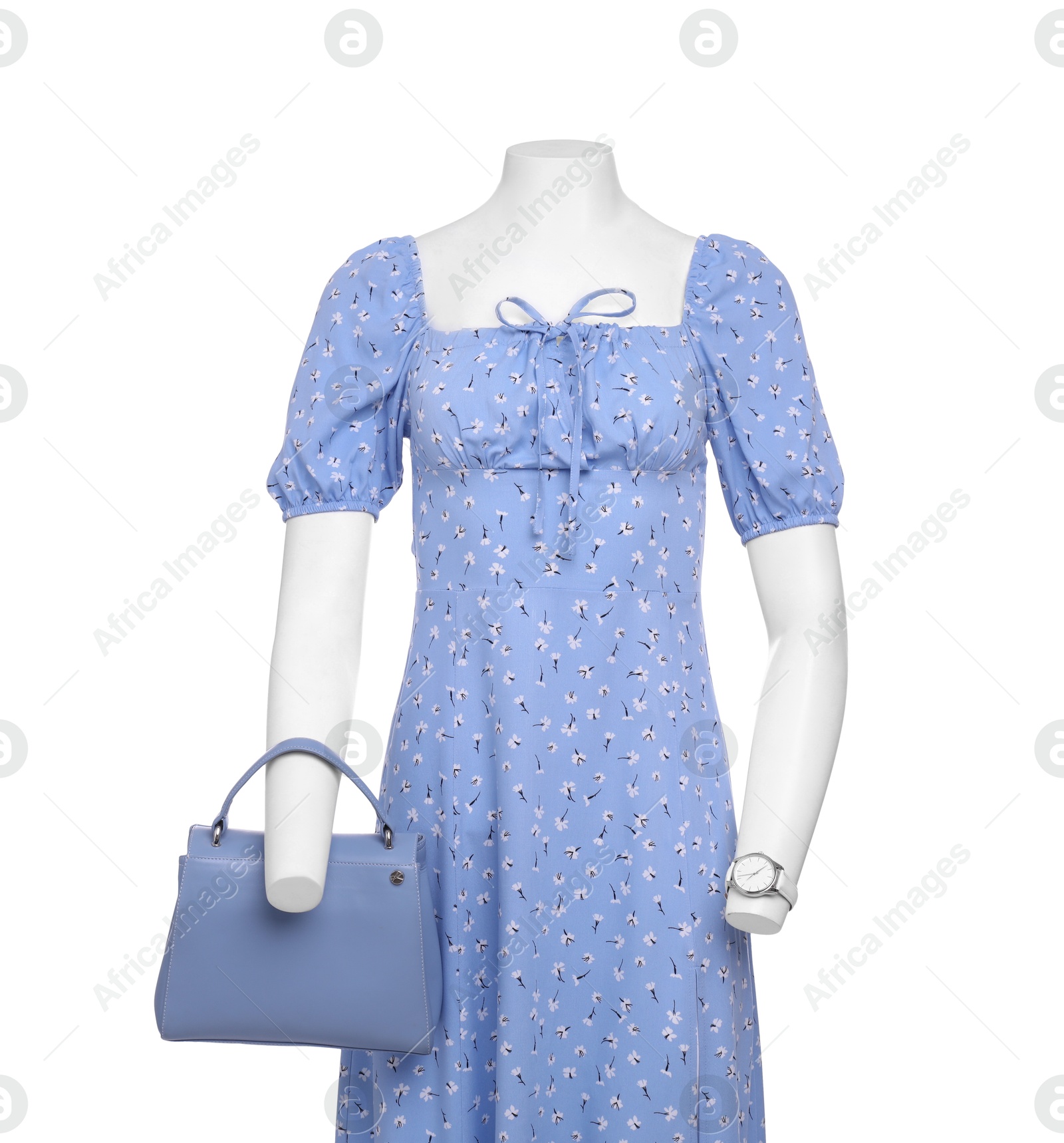 Photo of Female mannequin with accessories dressed in stylish light blue dress isolated on white