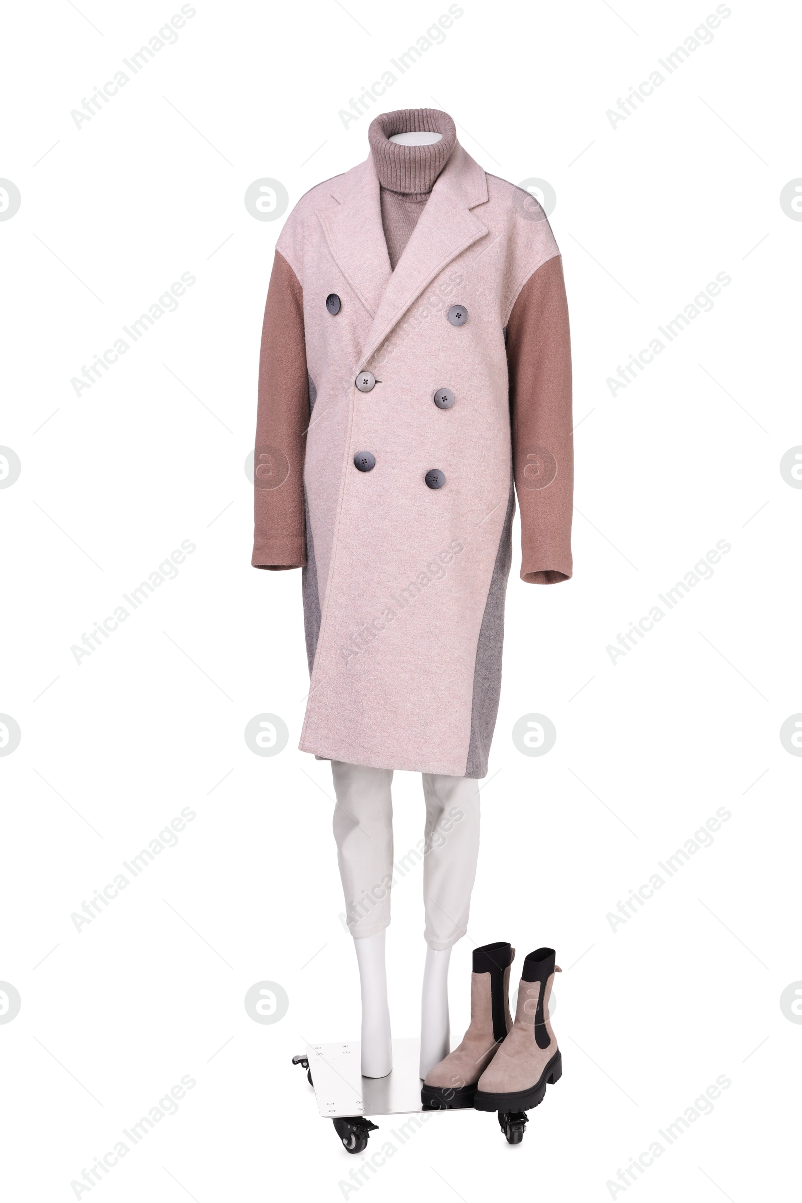 Photo of Female mannequin with shoes dressed in stylish coat, sweater and pants isolated on white