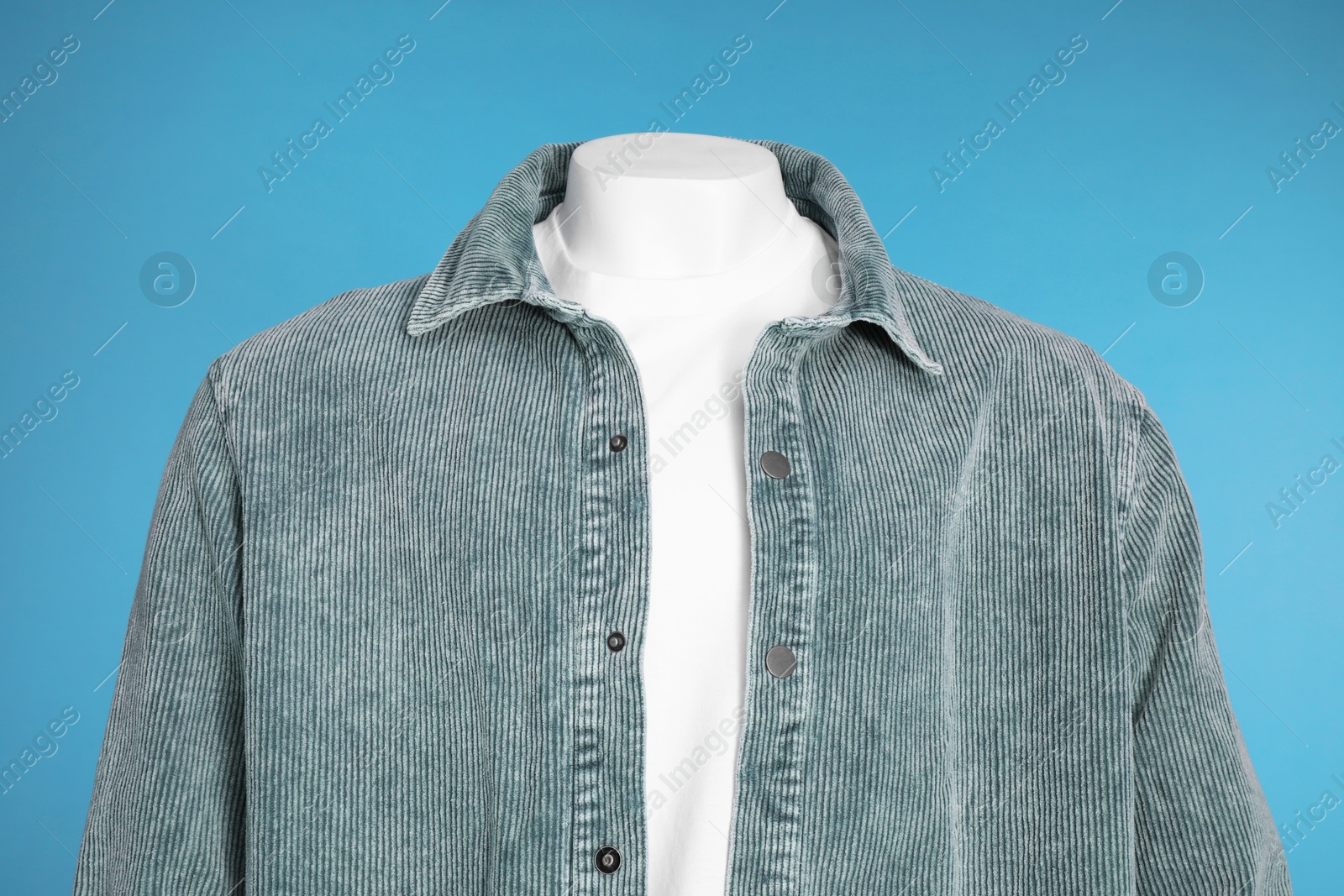 Photo of Male mannequin dressed in white t-shirt and stylish jacket on light blue background