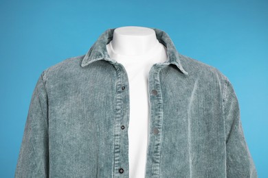 Photo of Male mannequin dressed in white t-shirt and stylish jacket on light blue background