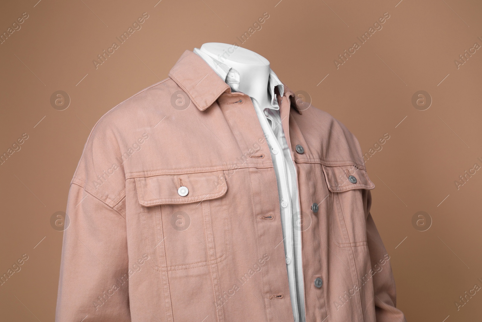 Photo of Male mannequin dressed in white shirt and jacket on beige background