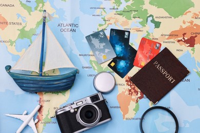 Photo of Travel blogger. Flat lay composition with vintage camera and map on light blue background