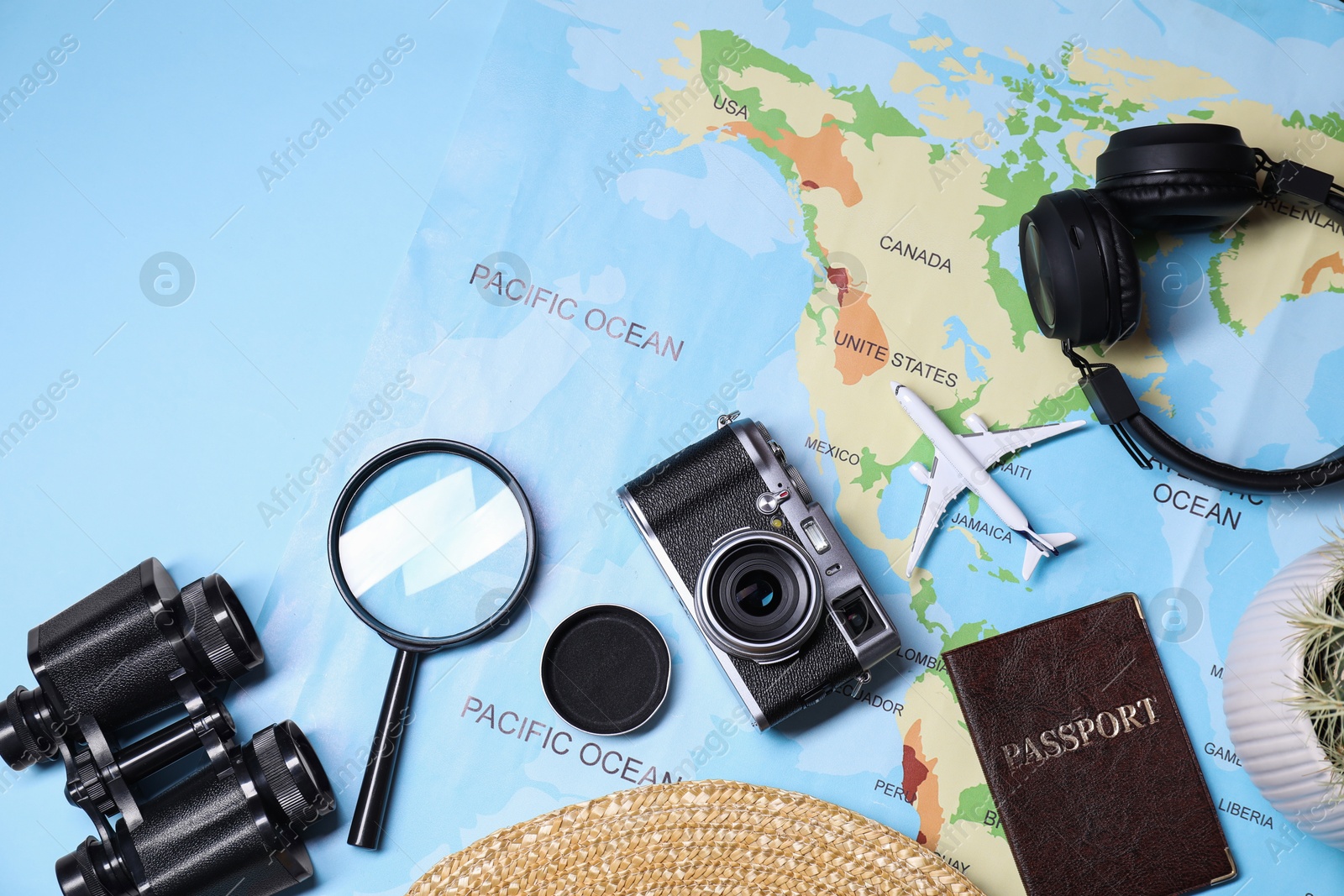 Photo of Flat lay composition with travel blogger`s items on light blue background