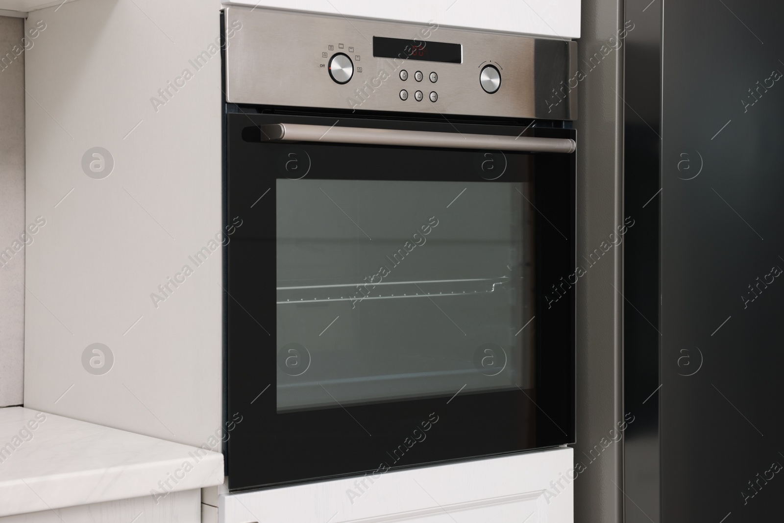 Photo of New electric oven in kitchen. Cooking appliance