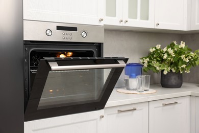 Photo of Open electric oven in kitchen. Cooking appliance