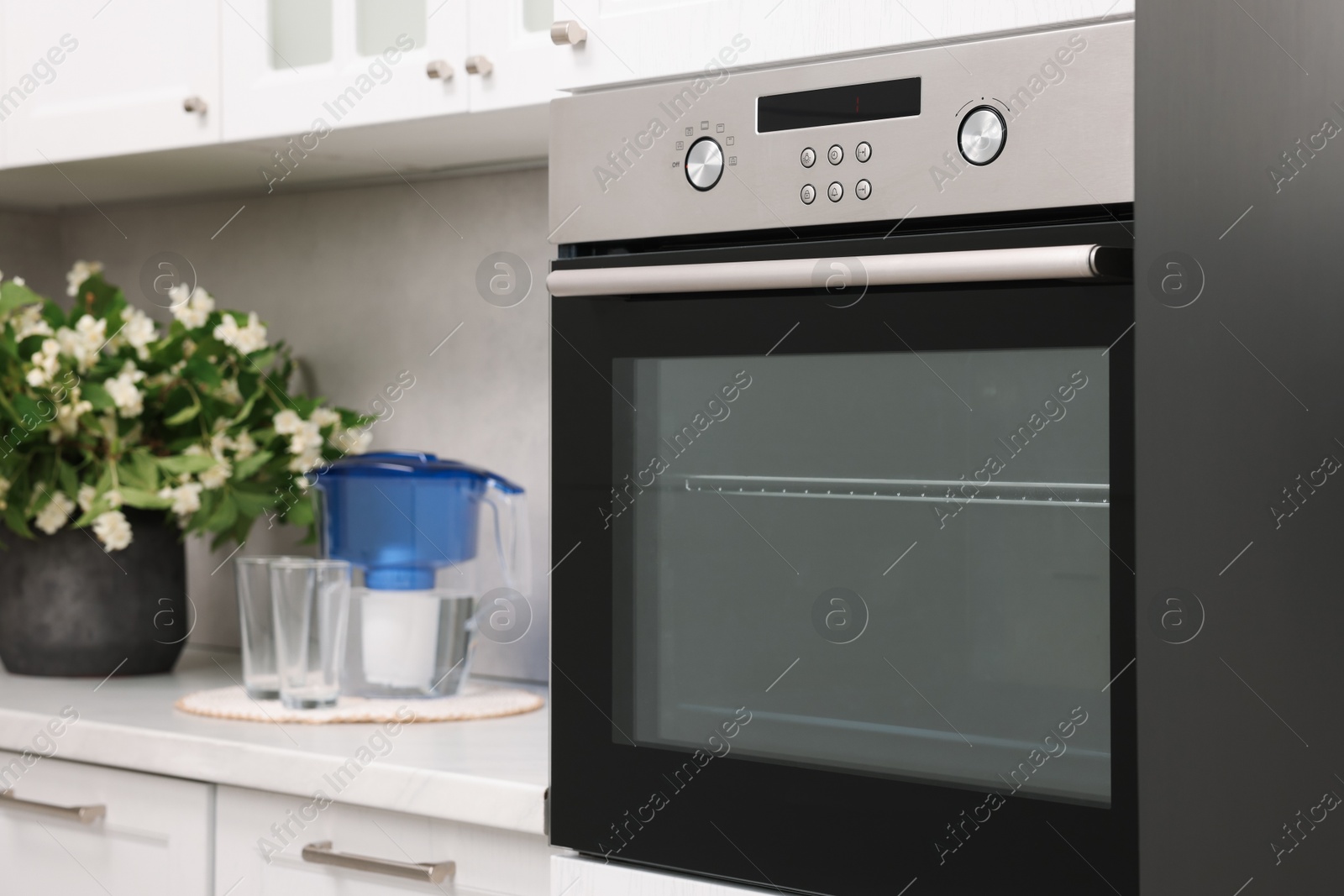 Photo of New electric oven in kitchen. Cooking appliance