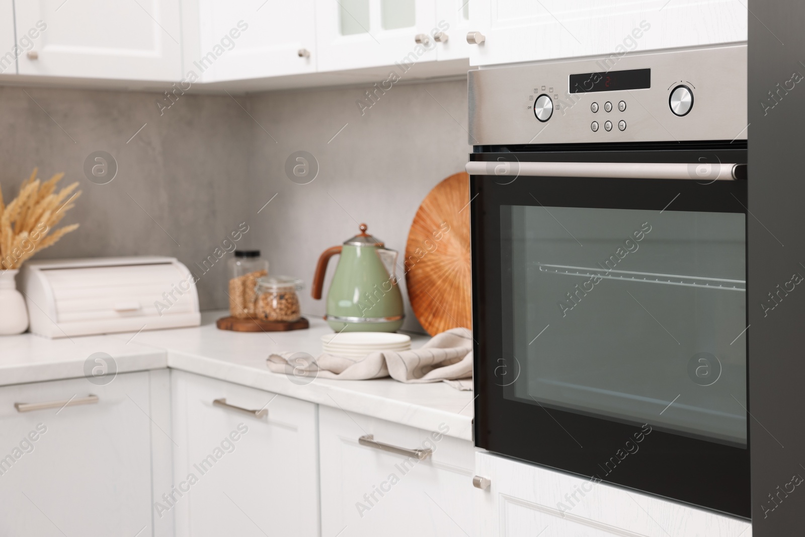 Photo of New electric oven in kitchen. Cooking appliance