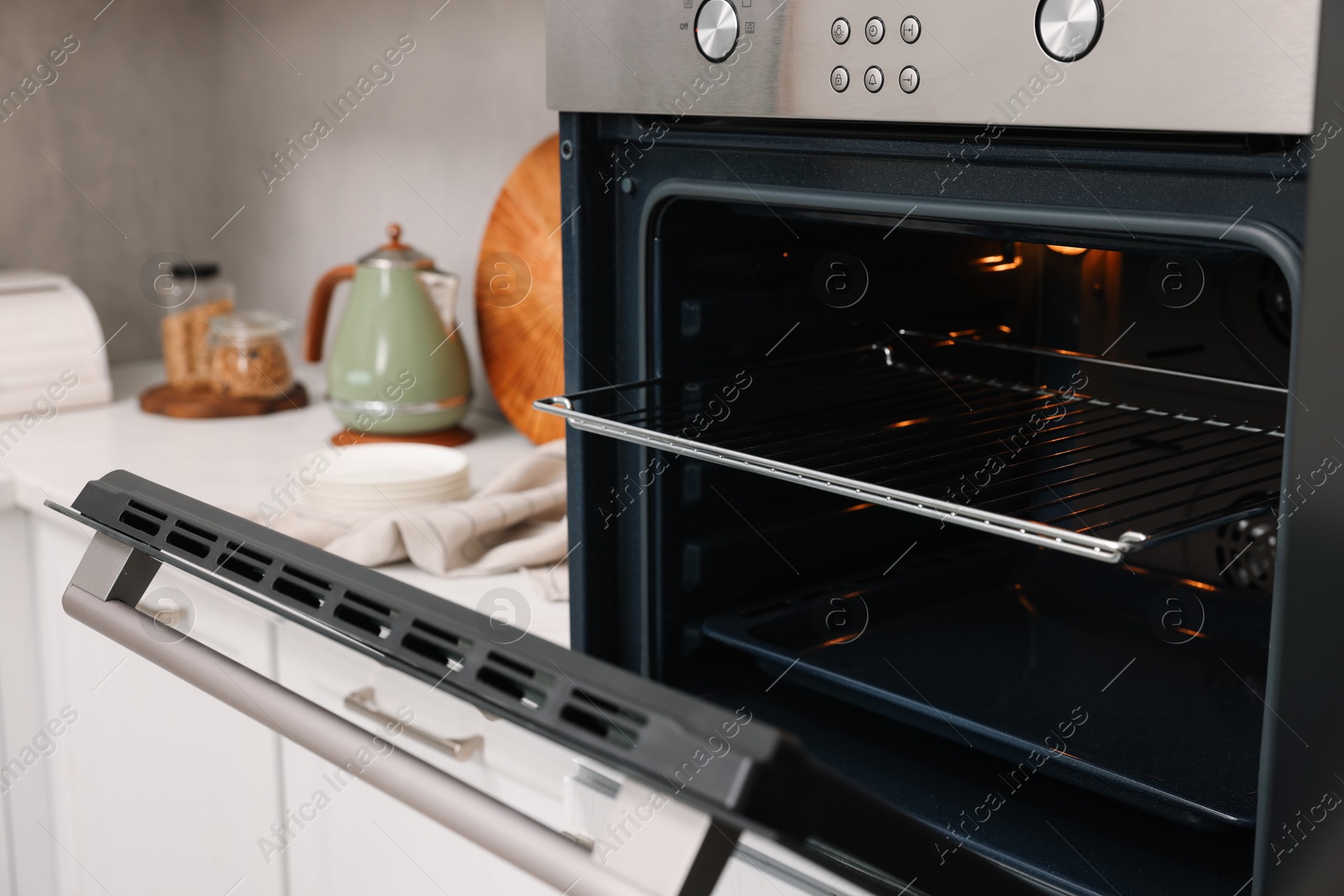 Photo of Open electric oven in kitchen. Cooking appliance