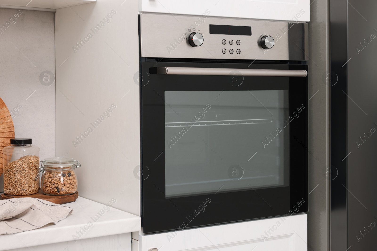 Photo of New electric oven in kitchen. Cooking appliance