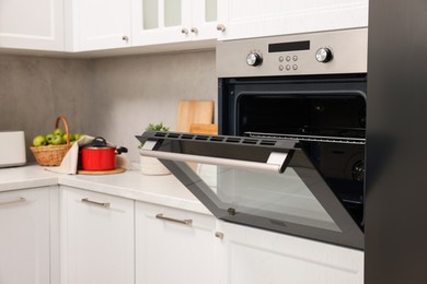 Photo of Open electric oven in kitchen. Cooking appliance