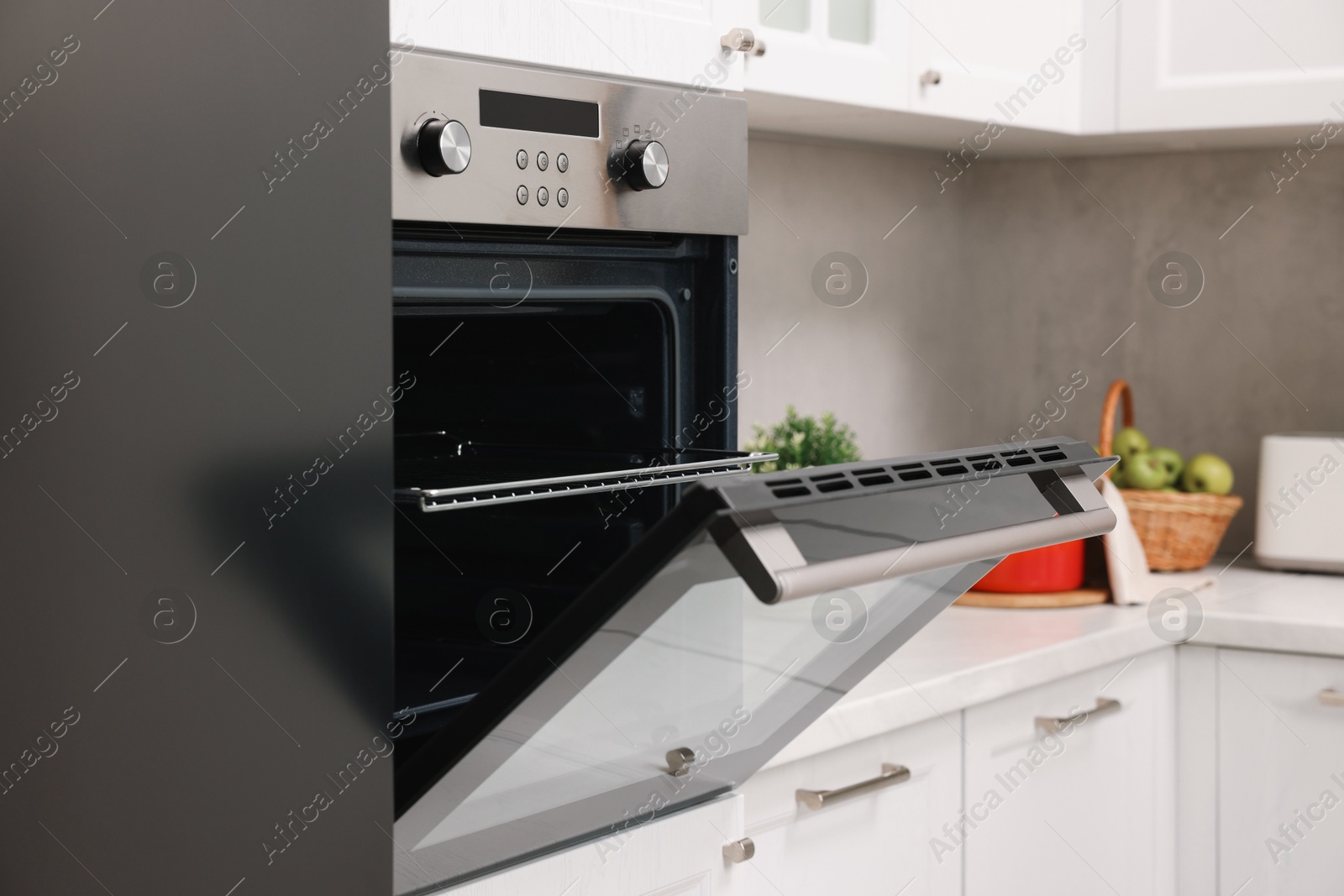 Photo of Open electric oven in kitchen. Cooking appliance