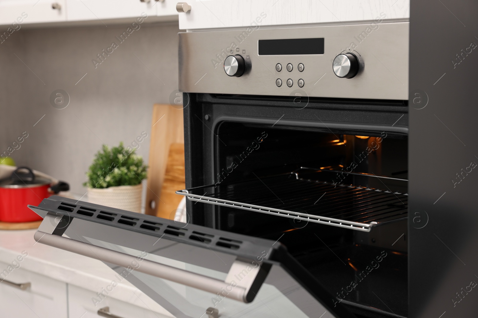 Photo of Open electric oven in kitchen. Cooking appliance