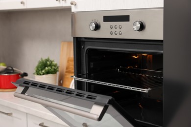 Photo of Open electric oven in kitchen. Cooking appliance