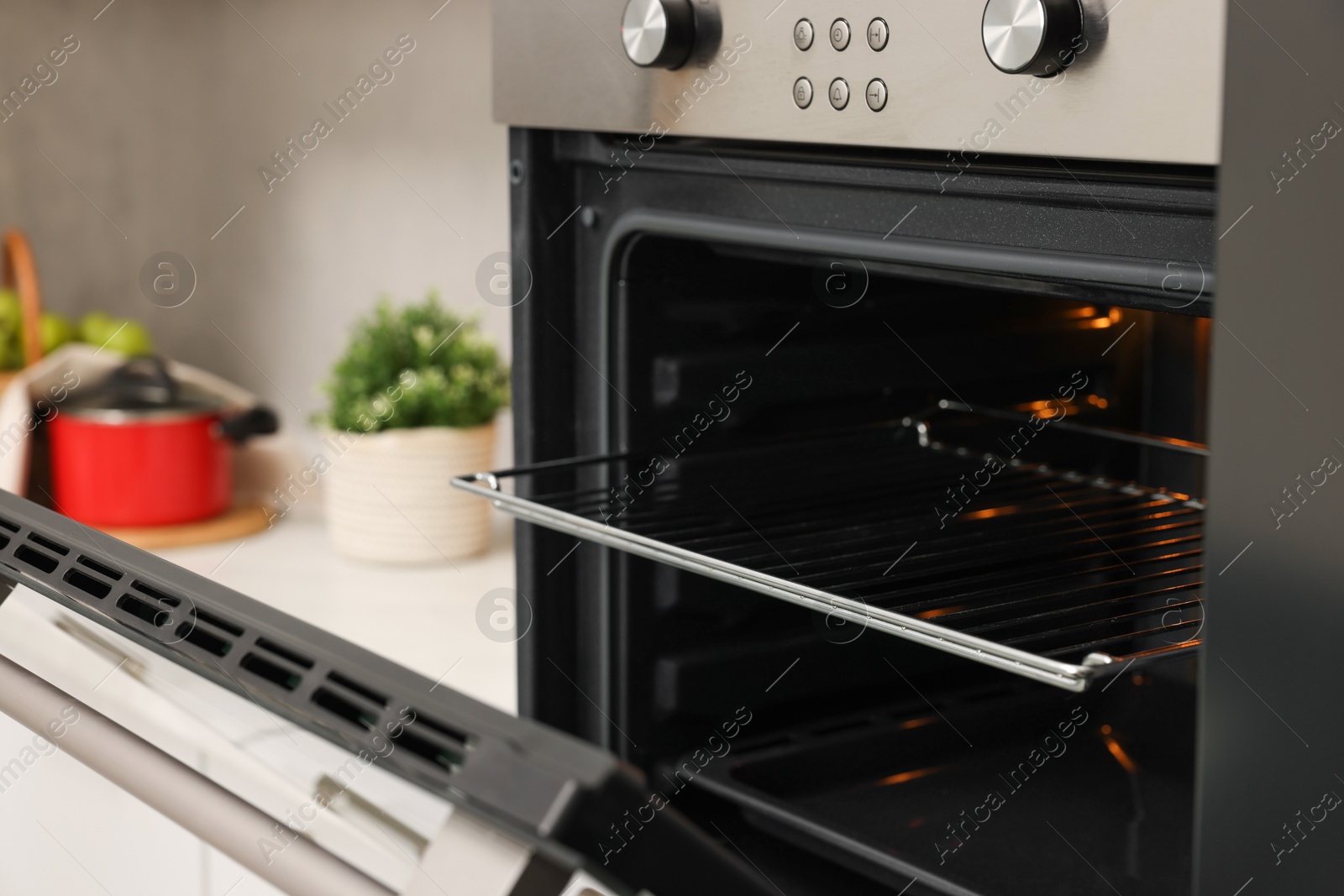 Photo of Open electric oven in kitchen. Cooking appliance