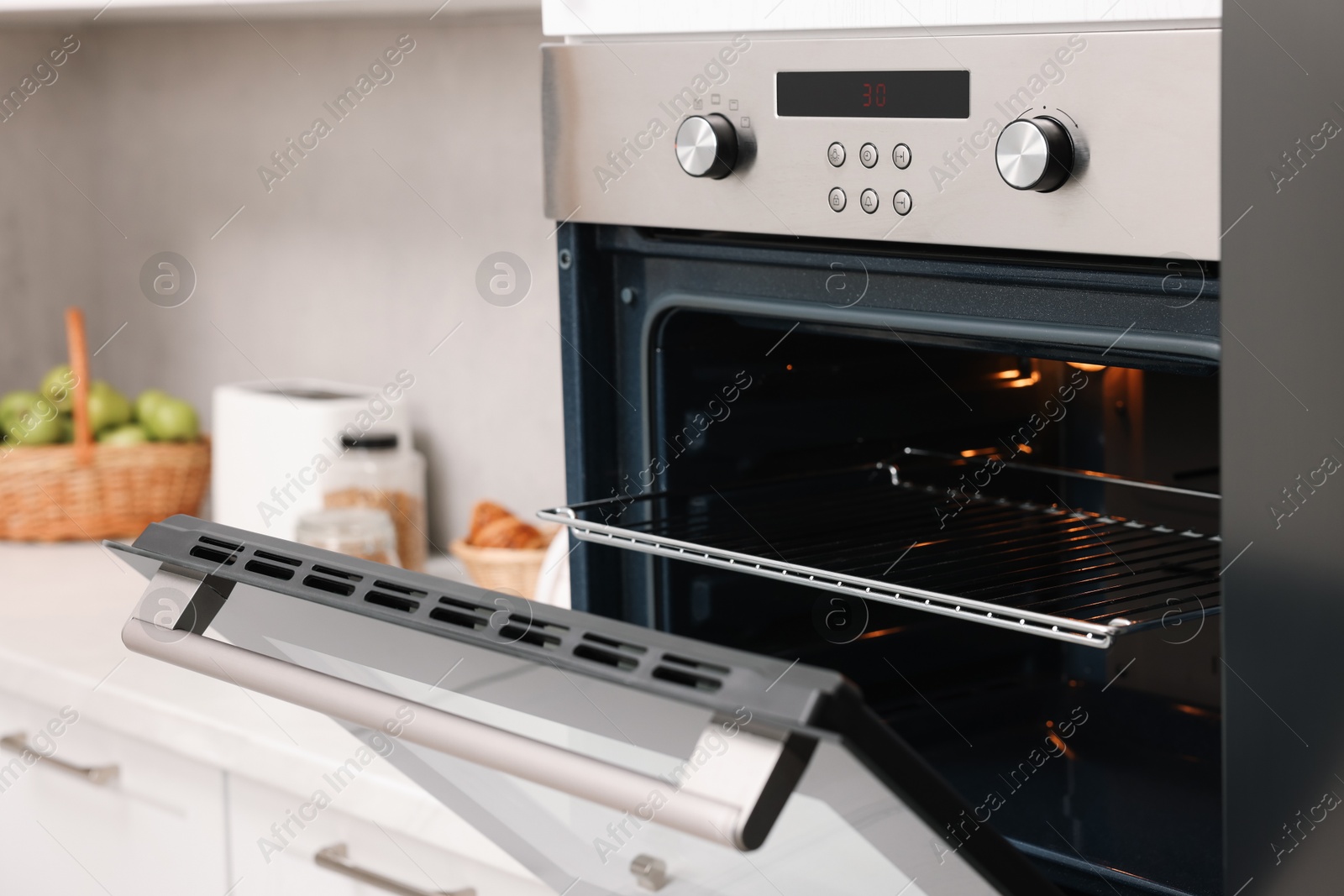 Photo of Open electric oven in kitchen. Cooking appliance