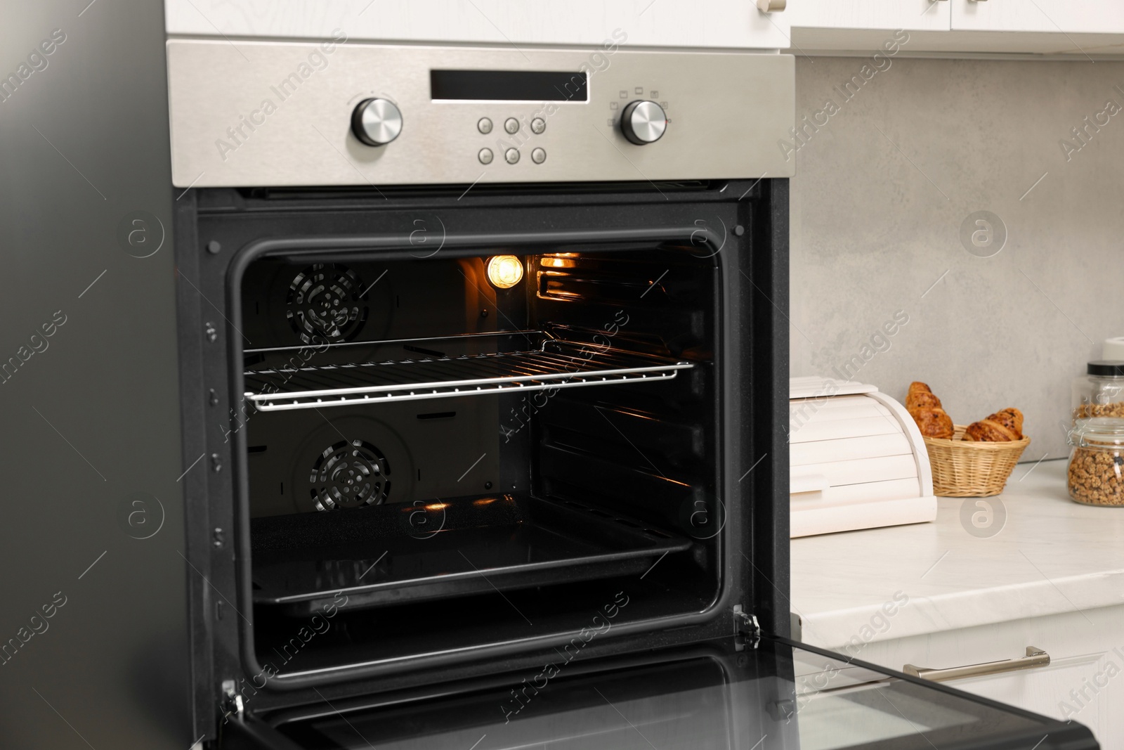 Photo of Open electric oven in kitchen. Cooking appliance