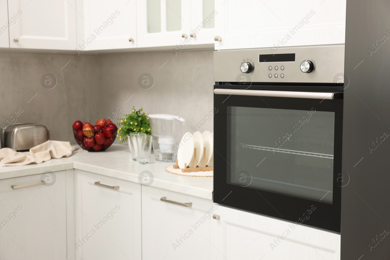 Photo of New electric oven in kitchen. Cooking appliance