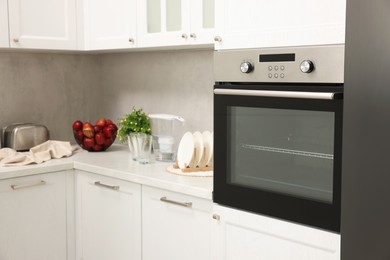 Photo of New electric oven in kitchen. Cooking appliance