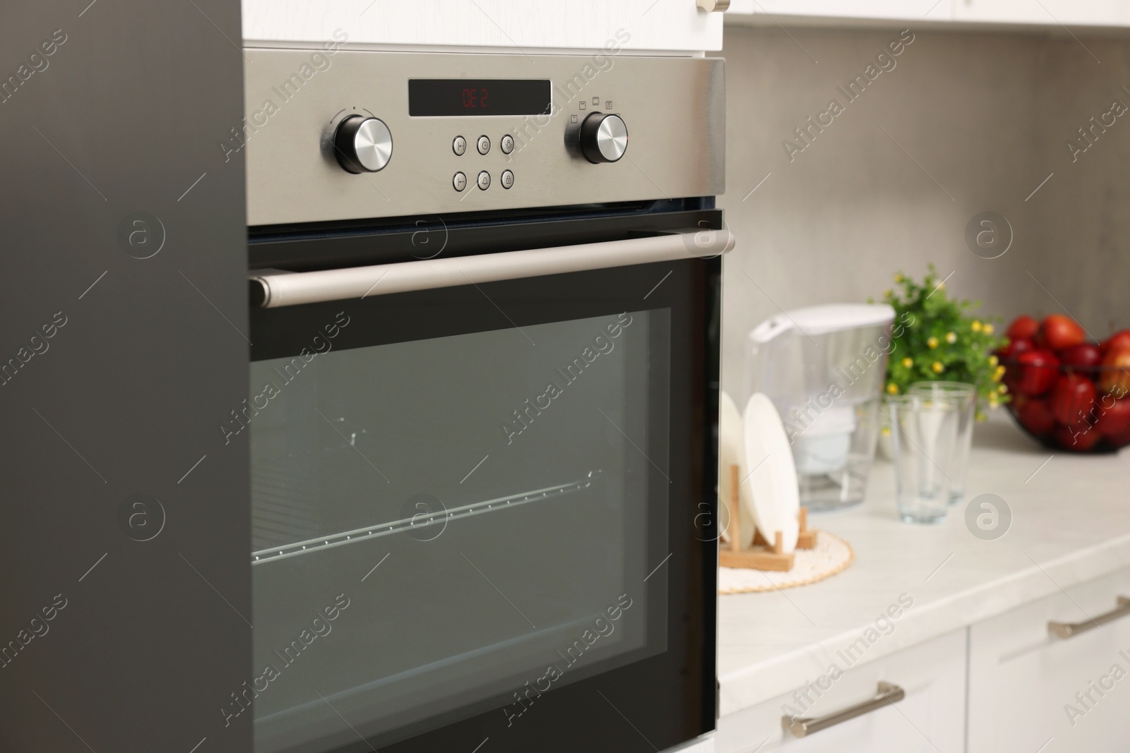 Photo of New electric oven in kitchen. Cooking appliance