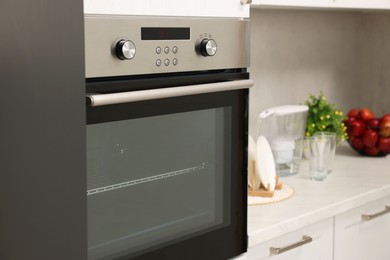 Photo of New electric oven in kitchen. Cooking appliance