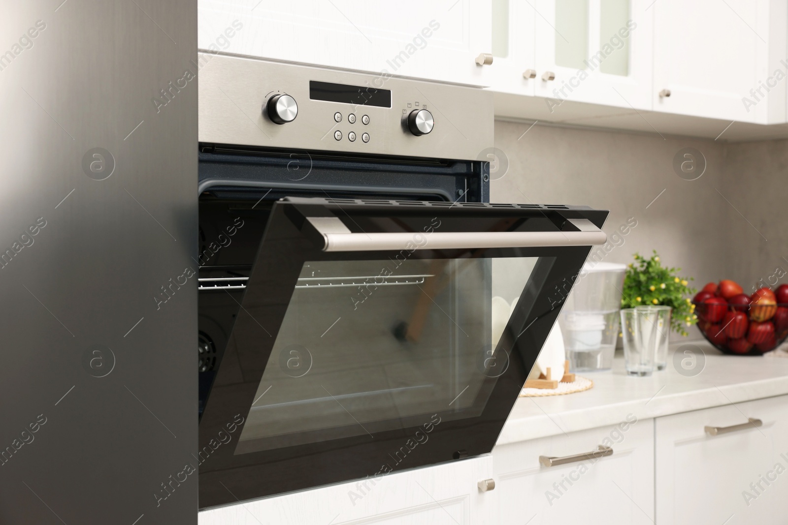 Photo of Open electric oven in kitchen. Cooking appliance