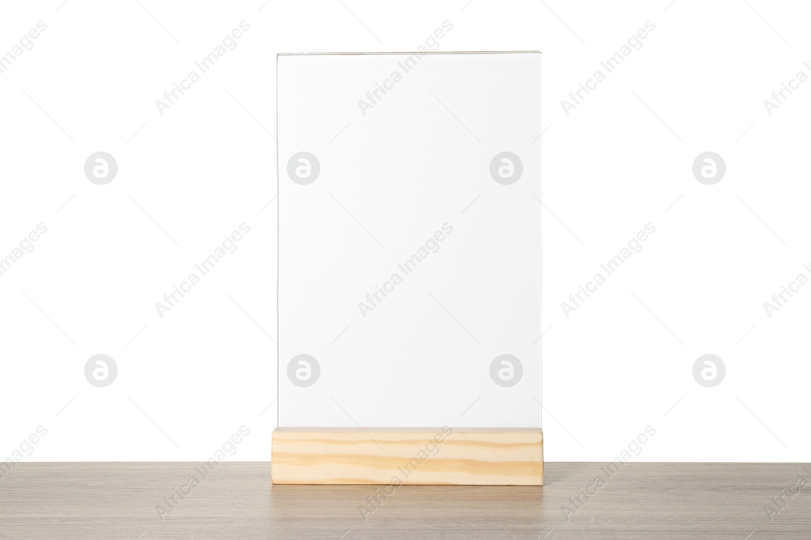 Photo of Menu holder on wooden table against white background. Mockup for design