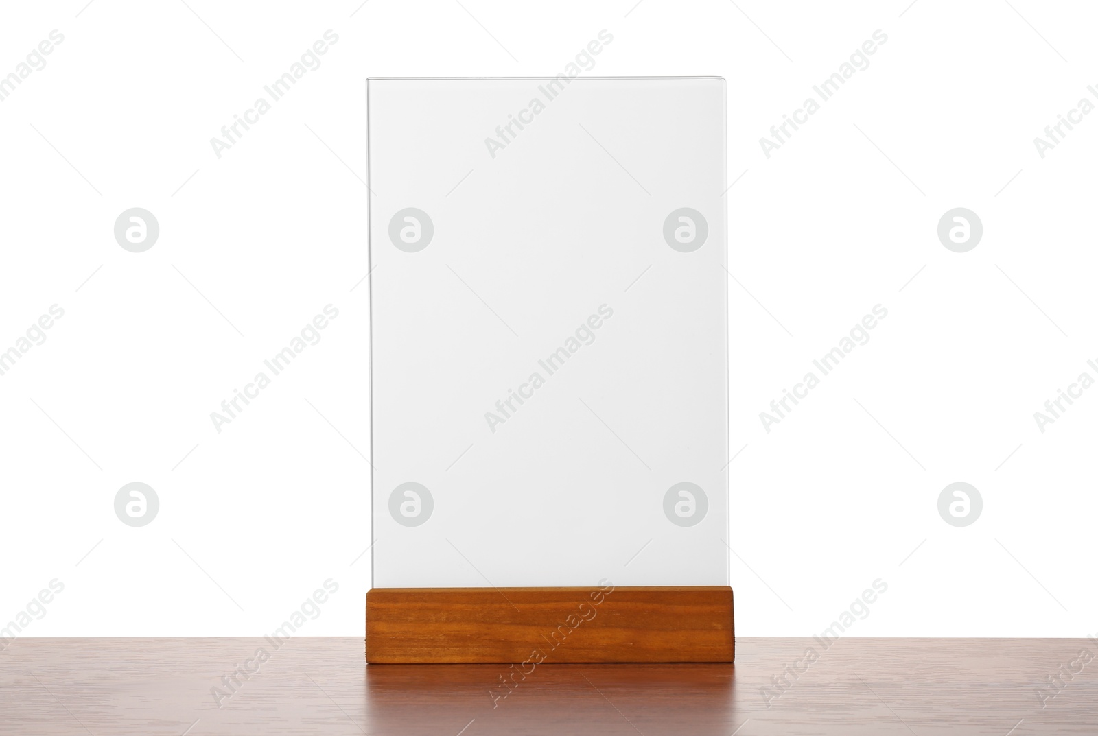 Photo of Menu holder on wooden table against white background. Mockup for design