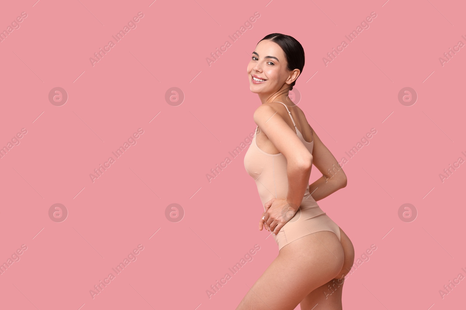 Photo of Smiling woman with perfect skin on pink background, space for text. Body care