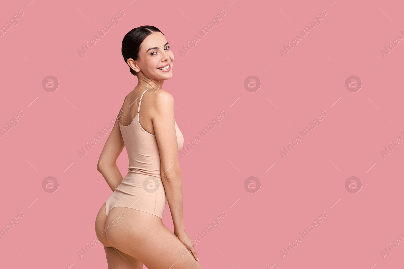 Photo of Smiling woman with perfect skin on pink background, space for text. Body care