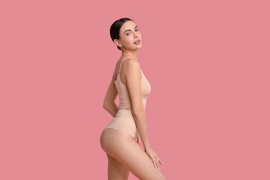 Photo of Beautiful woman with perfect skin on pink background. Body care