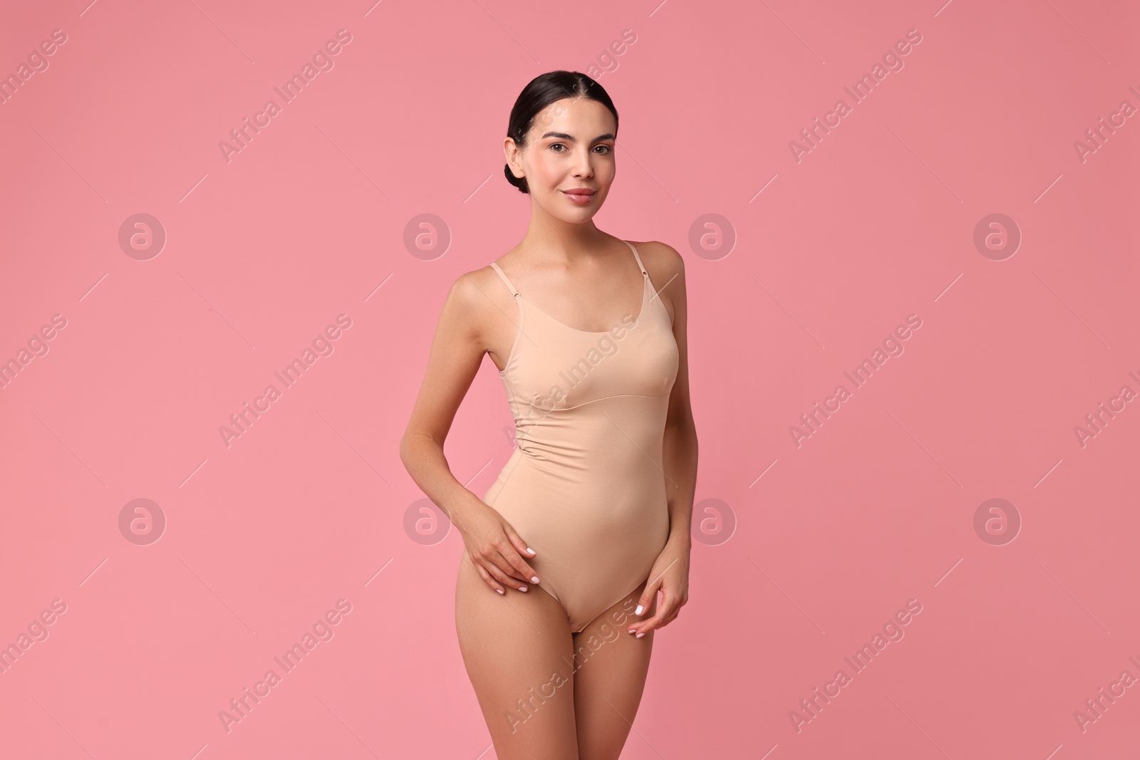 Photo of Beautiful woman with perfect skin on pink background. Body care