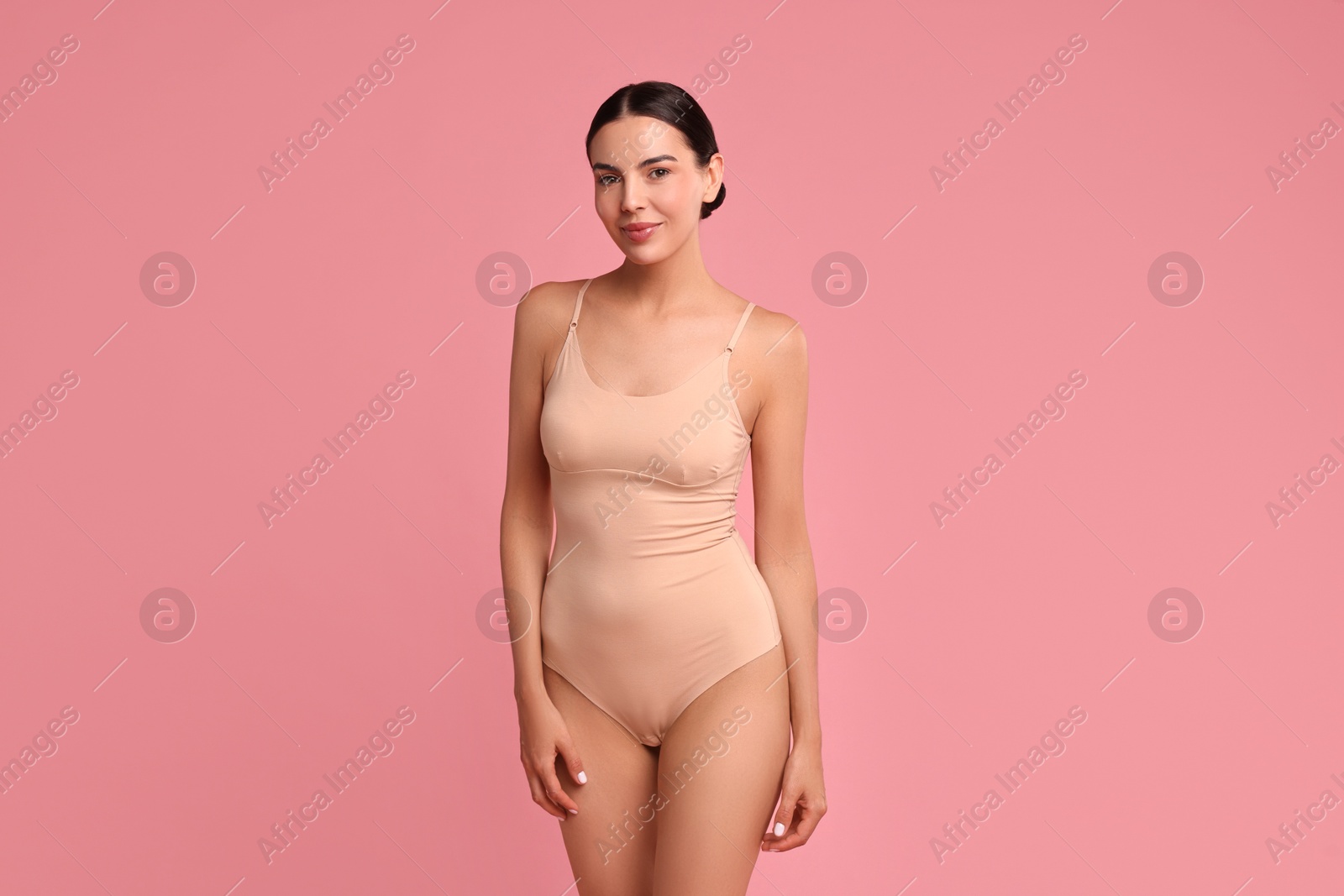 Photo of Beautiful woman with perfect skin on pink background. Body care