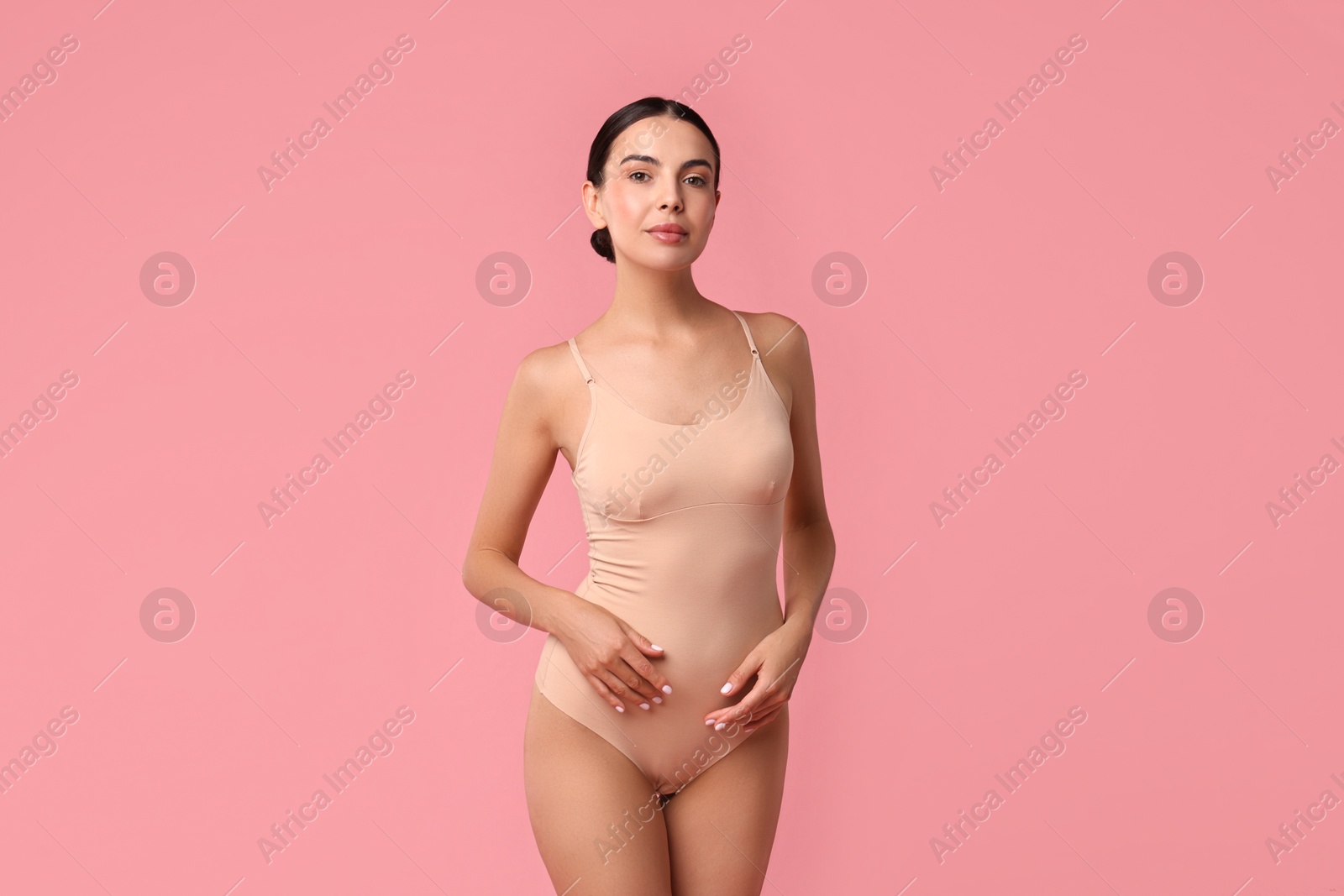 Photo of Beautiful woman with perfect skin on pink background. Body care