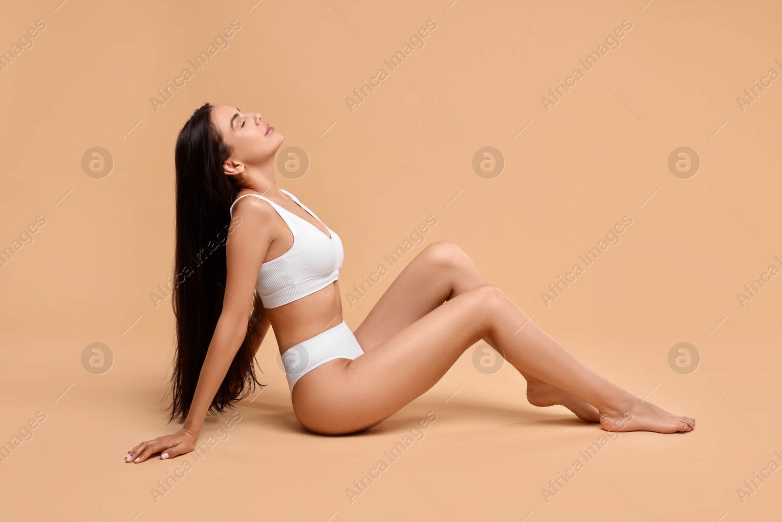 Photo of Beautiful woman with perfect skin on beige background. Body care