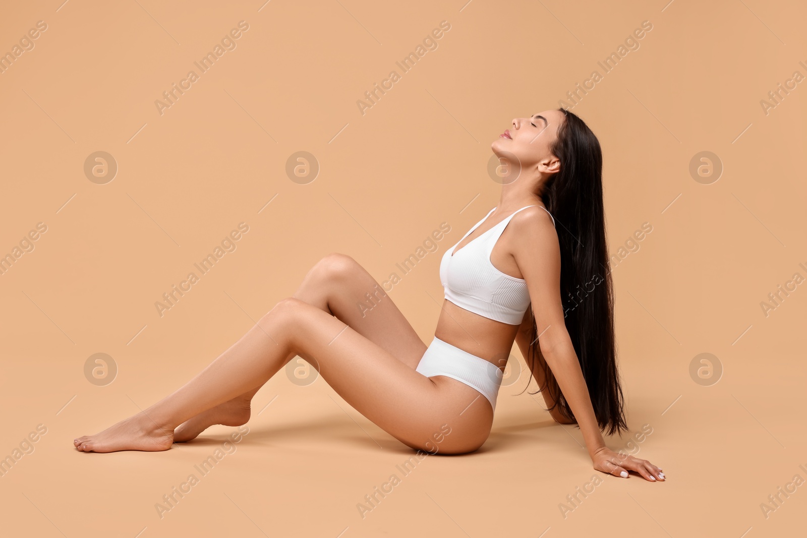 Photo of Beautiful woman with perfect skin on beige background. Body care