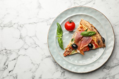 Photo of Tasty pizza with cured ham, olives, tomato and basil on white marble table, top view. Space for text