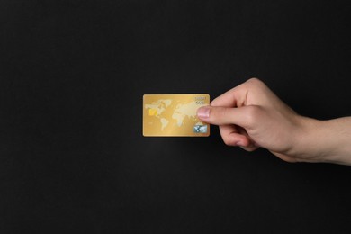 Photo of Man holding credit card on black background, closeup