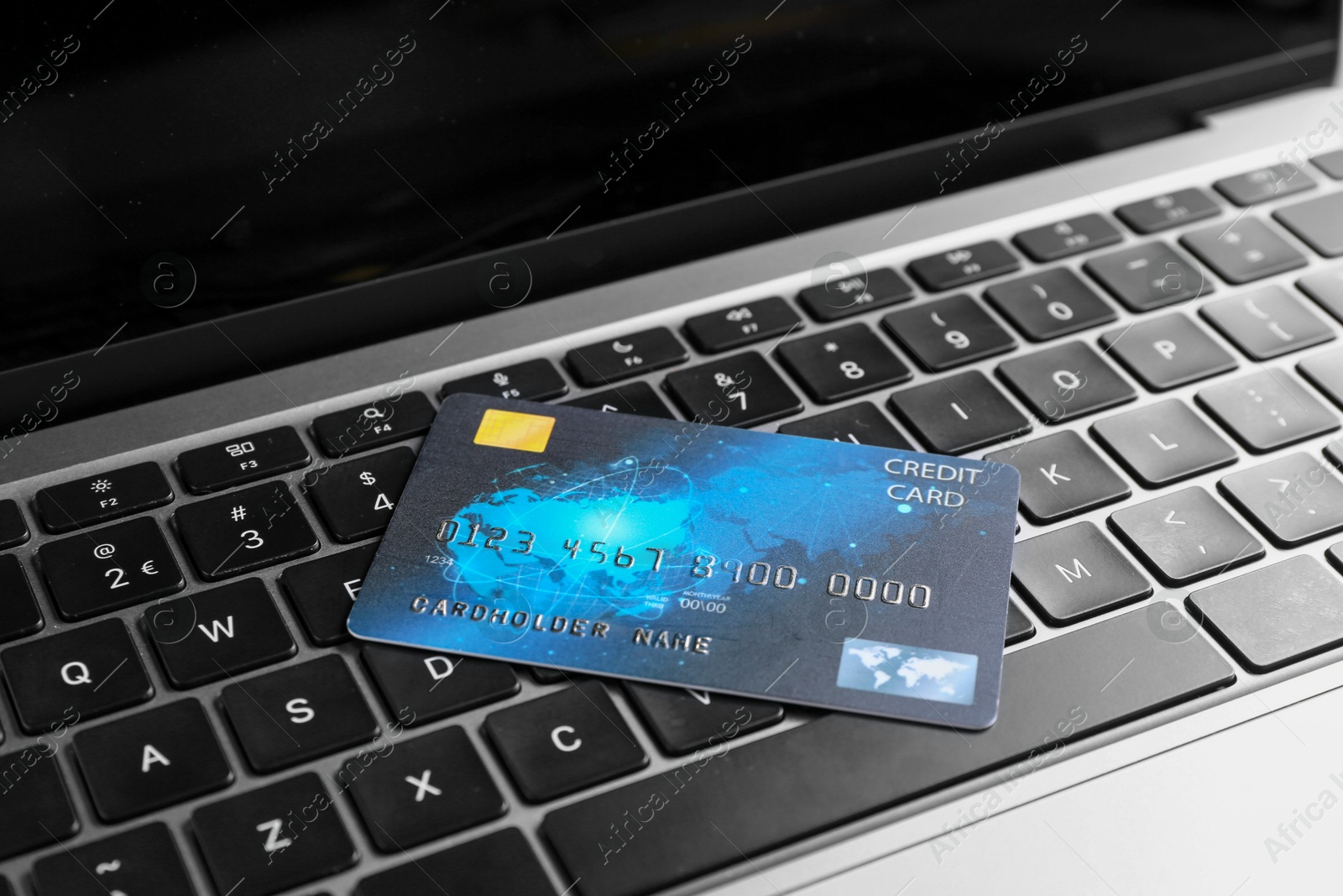 Photo of One plastic credit card on modern laptop