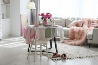 Beautiful table setting with pink peonies in living room