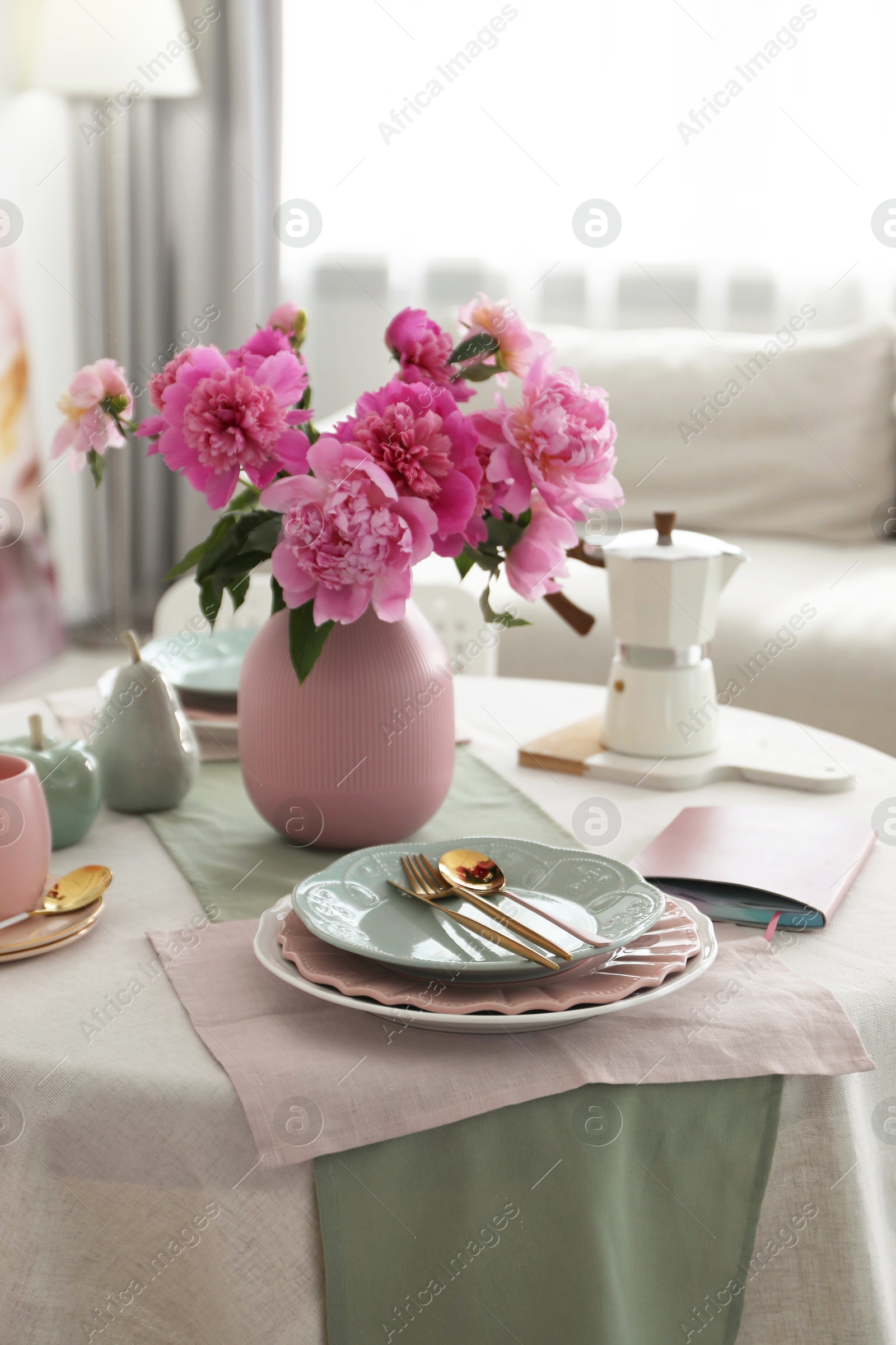 Photo of Beautiful table setting with pink peonies in dining room